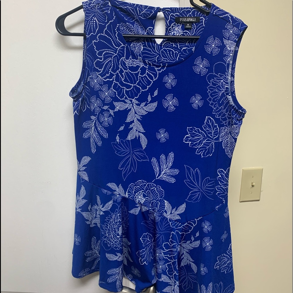 Sleeveless blue and white asymmetrical ruffled top.